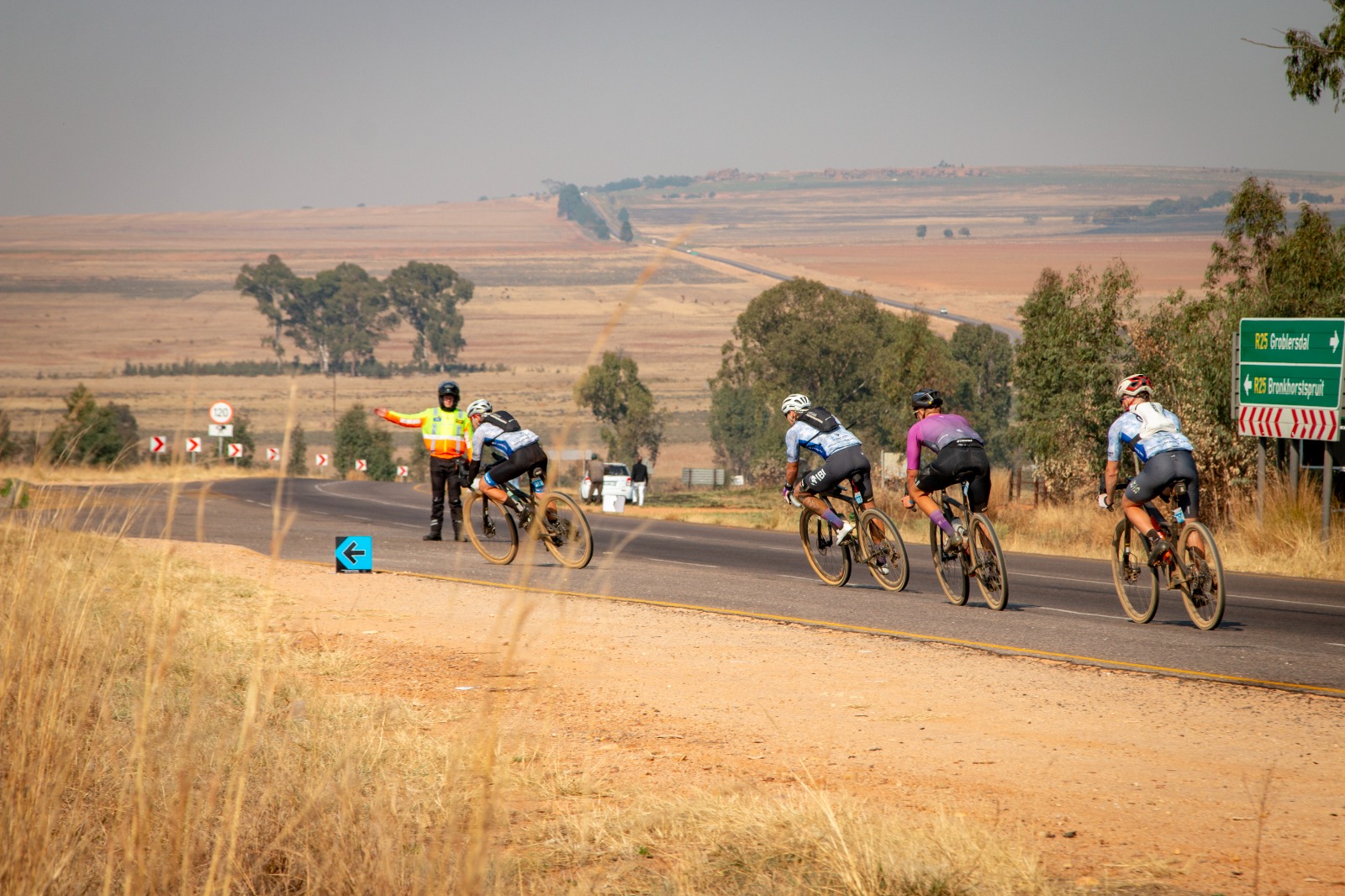 marshal directing riders onto dirt